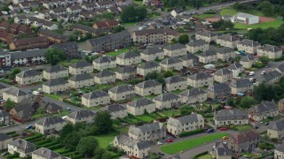 AX109_134E - 5.5K aerial stock footage of town houses in a Scottish neighborhood, Falkirk, Scotland