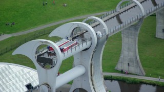 AX109_142 - 5.5K stock footage aerial video of ferries on the Falkirk Wheel boat lift, Scotland