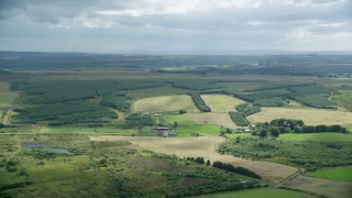 AX109_167 - 5.5K stock footage aerial video of farming fields and Scottish countryside, Bonnybridge, Scotland