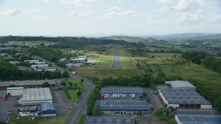 AX109_176 - 5.5K aerial stock footage of an approach to the Cumbernauld Airport runway, Scotland