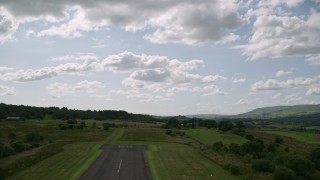 AX110_001 - 5.5K aerial stock footage of taking off from Cumbernauld Airport, Scotland