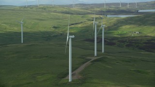AX110_013E - 5.5K aerial stock footage of windmills on green countryside, Denny, Scotland
