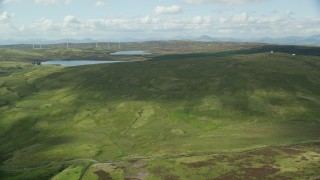AX110_016E - 5.5K aerial stock footage approach Earlsburn Reservoirs surrounded by green countryside, Scotland