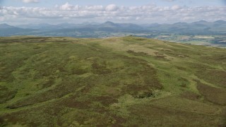 AX110_025 - 5.5K aerial stock footage approach Carleatheran in Gargunnock Hills, Scotland