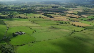 AX110_034E - 5.5K aerial stock footage fly over Scottish farms and fields near Kippen, Scotland