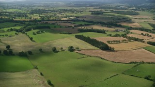 AX110_035 - 5.5K stock footage aerial video fly over Scottish farms and fields near Kippen, Scotland