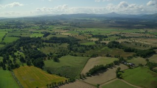 AX110_036 - 5.5K aerial stock footage video of flying over farm fields in a rural Scottish landscape, Buchlyvie, Scotland