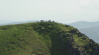 AX110_050 - 5.5K aerial stock footage flyby hikers on Ben Lomond mountain, Scottish Highlands, Scotland