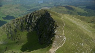 AX110_053 - 5.5K aerial stock footage of flyby dirt path on Ben Lomond mountain peak, Scottish Highlands, Scotland