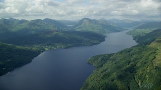 AX110_059E - 5.5K aerial stock footage of calm waters of Loch Lomond, Scottish Highlands, Scotland