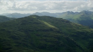 AX110_061E - 5.5K aerial stock footage approach a green mountain peak, Scottish Highlands, Scotland