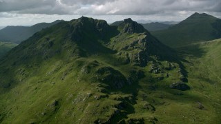 AX110_072 - 5.5K aerial stock footage approach The Cobbler, a green mountain peak, Scottish Highlands, Scotland