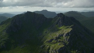 AX110_074E - 5.5K aerial stock footage of orbiting green mountain peak, The Cobbler, Scottish Highlands, Scotland