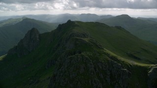 AX110_076 - 5.5K aerial stock footage of orbiting green mountain peak, The Cobbler, Scottish Highlands, Scotland