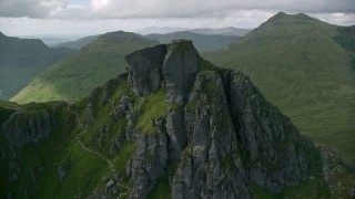 AX110_083 - 5.5K aerial stock footage of orbiting a jagged summit of The Cobbler, Scottish Highlands, Scotland