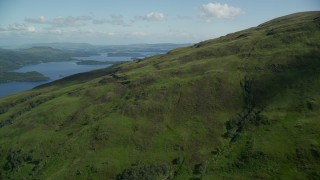 AX110_101E - 5.5K aerial stock footage approach blue waters of Loch Lomond, Scottish Highlands