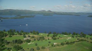 AX110_118 - 5.5K aerial stock footage of orbiting Loch Lomond Golf Course, Luss, Scottish Highlands, Scotland