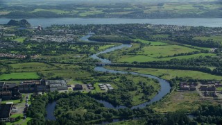 AX110_136E - 5.5K aerial stock footage approach River Leven and waterfront town, Dumbarton, Scotland
