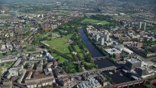 AX110_160E - 5.5K aerial stock footage of monument and museum at Glasgow Green park by River Clyde, Scotland