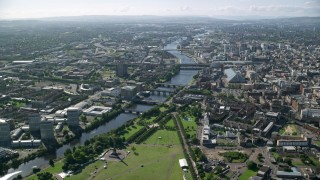 AX110_163 - 5.5K stock footage aerial video of River Clyde and bridges near city buildings, Glasgow, Scotland