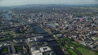AX110_166E - 5.5K aerial stock footage of River Clyde with bridges by city buildings, Glasgow, Scotland