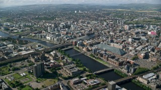 AX110_167 - 5.5K stock footage aerial video of River Clyde with bridges by city buildings, Glasgow, Scotland