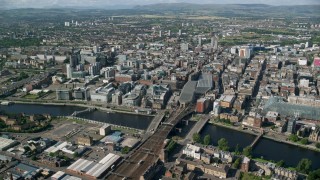 AX110_168 - 5.5K aerial stock footage of River Clyde bridges, Glasgow Central Station, and city buildings, Glasgow, Scotland