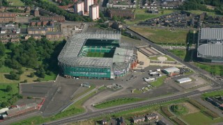 AX110_186 - 5.5K stock footage aerial video approach Celtic Park soccer stadium, Glasgow, Scotland