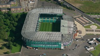 AX110_187 - 5.5K stock footage aerial video approach Celtic Park soccer stadium in Glasgow, Scotland