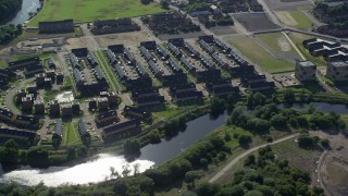 AX110_189 - 5.5K stock footage aerial video of riverfront row houses along River Clyde, Glasgow, Scotland