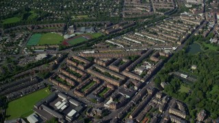 AX110_198 - 5.5K aerial stock footage of rows of apartment buildings, Glasgow, Scotland