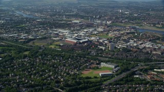 AX110_199E - 5.5K aerial stock footage approach Ibrox Stadium, tilt to bird's eye of soccer field, Glasgow, Scotland