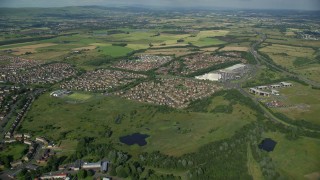 AX110_217E - 5.5K aerial stock footage of a roundabout and residential neighborhood, Glasgow, Scotland