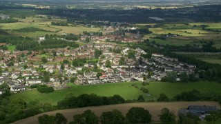 AX110_234 - 5.5K aerial stock footage of rural homes in a village, Bonnybridge, Scotland