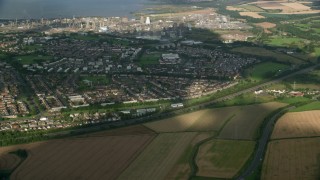 AX111_009 - 5.5K aerial stock footage of suburban houses and gas power plant, Falkirk, Scotland