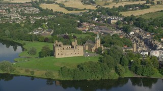 AX111_013E - 5.5K aerial stock footage orbit Linlithgow Palace and the St. Michael's Parish Church, Scotland