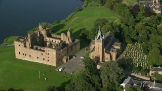 AX111_015 - 5.5K stock footage aerial video of an orbit of iconic Linlithgow Palace and St. Michael's Parish, Scotland