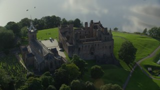 AX111_018E - 5.5K aerial stock footage of an orbit around historic Linlithgow Palace and St. Michael's Parish Church, Linlithgow, Scotland