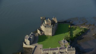AX111_037E - 5.5K aerial stock footage of an orbit of the iconic Blackness Castle on the bank of the River Forth, Scotland