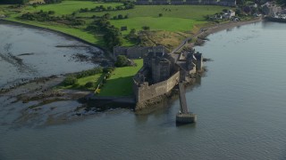 AX111_041E - 5.5K aerial stock footage of orbiting Blackness Castle on the side of River Forth, Scotland