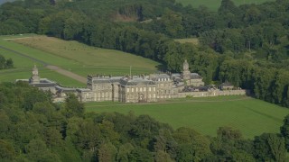 AX111_046E - 5.5K aerial stock footage of zooming to a wider view while passing Hopetoun House, Scotland