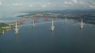 AX111_061E - 5.5K aerial stock footage video of the Forth Road Bridge and Forth Bridge on Firth of Forth, Scotland