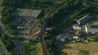 AX111_066 - 5.5K aerial stock footage of tracking a commuter train traveling through North Queensferry, Scotland
