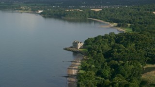 AX111_086 - 5.5K aerial stock footage of iconic Barnbougle Castle beside Firth of Forth in Edinburgh, Scotland