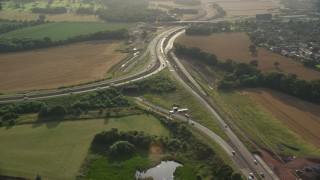 AX111_094E - 5.5K aerial stock footage of M90 highway Interchange and farmland, South Queensferry, Scotland
