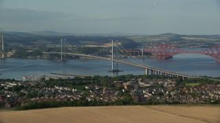 AX111_099E - 5.5K aerial stock footage of Forth Road Bridge and Firth of Forth, Edinburgh, Scotland