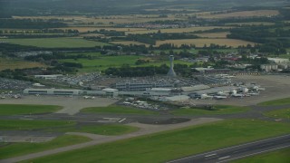 AX111_105E - 5.5K aerial stock footage of the Edinburgh Airport and farmland, Scotland