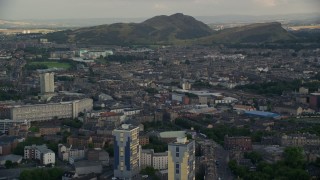 AX111_123E - 5.5K aerial stock footage of the Easter Road soccer stadium and Arthur's Seat mountain peak, Edinburgh, Scotland