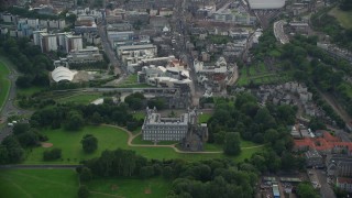 AX111_129E - 5.5K aerial stock footage of Holyrood Palace, Scottish Parliament and Canongate, Edinburgh, Scotland