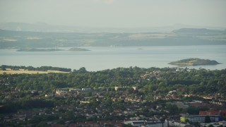AX111_167 - 5.5K aerial stock footage of suburban neighborhood near Firth of Forth, Edinburgh, Scotland